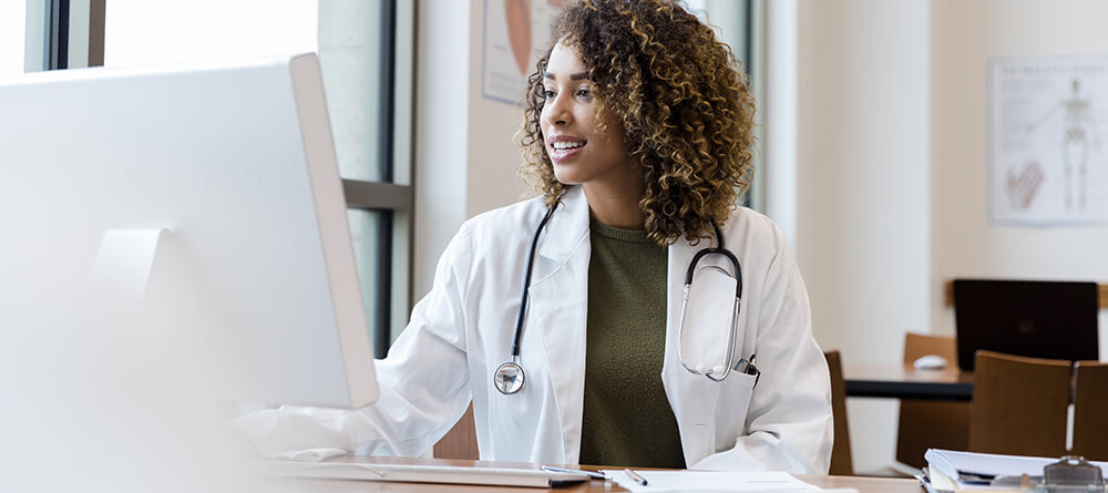 Female doctor using Apple computer